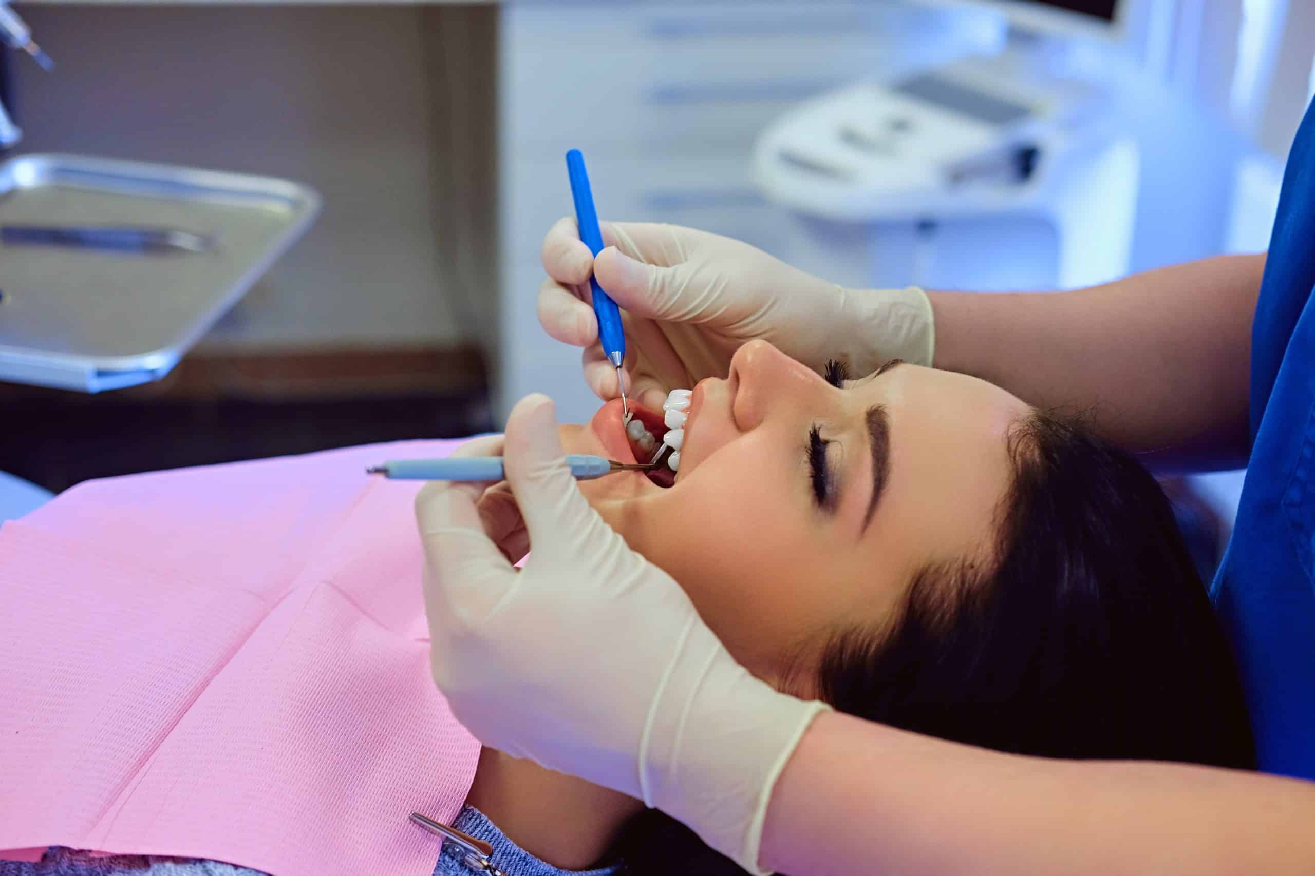 a lady is having dental treatment