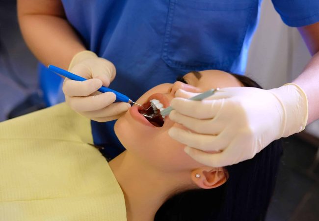 a lady is getting dental treatment near douglasdale