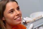 a dentist is testing dental crown demo to a patient