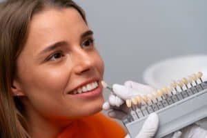 a dentist is testing dental crown demo to a patient