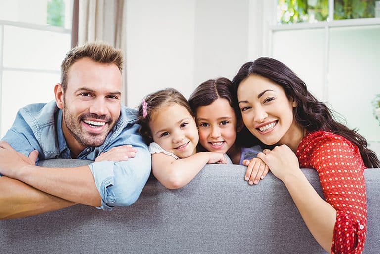 a family is smiling and clinic photo