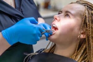 a lady is fixing her broken teeth
