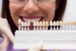 dentist showing porcelain veneer to a patient