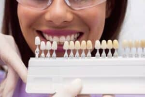 dentist showing porcelain veneer to a patient