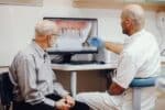 dentist showing dental implant report to patient