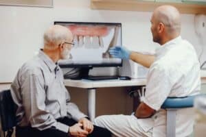 dentist showing dental implant report to patient